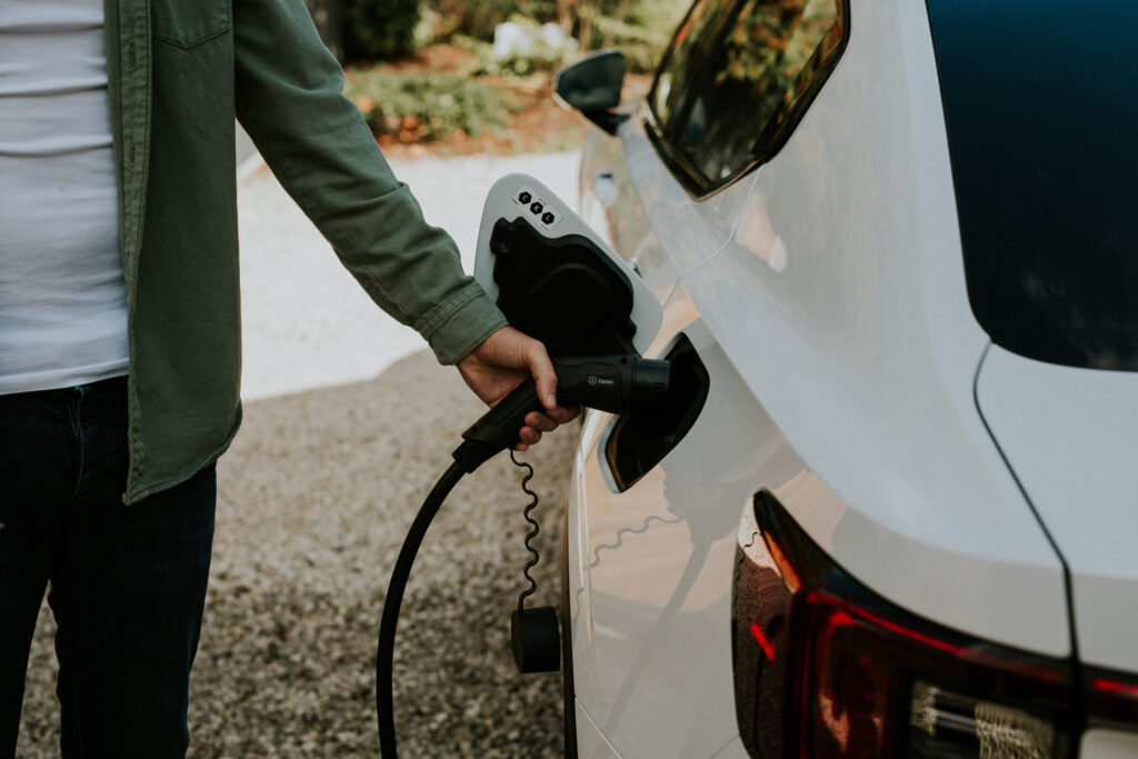 Woman plugging in Zaptec Go charger into car